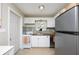 Bright kitchen boasts white cabinetry, wood countertops and stainless steel appliances at 5365 Flamingo Dr, St Petersburg, FL 33714