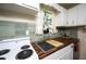 Close-up highlighting the sink, wood countertops, and stylish backsplash at 5365 Flamingo Dr, St Petersburg, FL 33714
