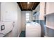 This laundry room boasts bright white walls, and ample shelving for all of your storage needs at 5365 Flamingo Dr, St Petersburg, FL 33714