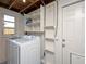 This laundry room offers a laundry machine, as well as ample shelving for all of your storage needs at 5365 Flamingo Dr, St Petersburg, FL 33714