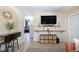 Bright living room with a large TV and decorative shelves, blending modern living with a touch of elegance at 5365 Flamingo Dr, St Petersburg, FL 33714
