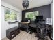 This office features a striking black accent wall, creating a sophisticated and productive workspace at 5365 Flamingo Dr, St Petersburg, FL 33714