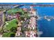 Aerial view of waterfront condos with a golf course, marina, and bridge in the background at 5736 La Puerta Del Sol S Blvd # 254, St Petersburg, FL 33715