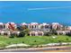 Beautiful aerial view of a condo community and golf course near the water with a boat speeding by at 5736 La Puerta Del Sol S Blvd # 254, St Petersburg, FL 33715
