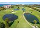 Expansive aerial view of lush golf course with water hazards and manicured greens at 5736 La Puerta Del Sol S Blvd # 254, St Petersburg, FL 33715