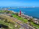 Stunning aerial view of waterfront condos, a golf course, and a marina, providing scenic coastal living at 5736 La Puerta Del Sol S Blvd # 254, St Petersburg, FL 33715