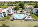 Aerial view of waterfront community pool with tiki umbrellas and bay views at 5736 La Puerta Del Sol S Blvd # 254, St Petersburg, FL 33715