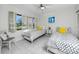 Inviting bedroom with twin beds, white tile floors, plantation shutters, and abundant natural light at 5736 La Puerta Del Sol S Blvd # 254, St Petersburg, FL 33715