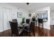 Cozy dining room with modern light fixture, and hardwood floors, leading to kitchen bar at 5736 La Puerta Del Sol S Blvd # 254, St Petersburg, FL 33715