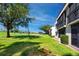 Peaceful condo exterior overlooking a lush golf course with mature trees and beautiful green grass at 5736 La Puerta Del Sol S Blvd # 254, St Petersburg, FL 33715