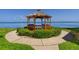 Picturesque waterfront gazebo nestled in lush greenery, offering a serene spot for relaxation and scenic views at 5736 La Puerta Del Sol S Blvd # 254, St Petersburg, FL 33715