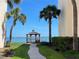 Scenic waterfront gazebo with palm trees and lush green grass offering a tranquil retreat at 5736 La Puerta Del Sol S Blvd # 254, St Petersburg, FL 33715