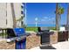 Outdoor grill area with stone counters, built-in grills, and stunning bay views, perfect for entertaining at 5736 La Puerta Del Sol S Blvd # 254, St Petersburg, FL 33715