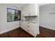 White kitchen with hardwood floors and natural light at 5736 La Puerta Del Sol S Blvd # 254, St Petersburg, FL 33715