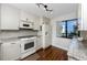 Bright kitchen with granite countertops, white cabinets, modern appliances, and wood floors at 5736 La Puerta Del Sol S Blvd # 254, St Petersburg, FL 33715