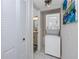 Functional laundry area with a stacked washer and dryer, next to a closet and adjacent to the bathroom at 5736 La Puerta Del Sol S Blvd # 254, St Petersburg, FL 33715