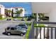View of the parking lot with multiple cars and palm trees with a peek of the ocean in the background at 5736 La Puerta Del Sol S Blvd # 254, St Petersburg, FL 33715