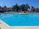 Enjoy the refreshing community pool with clear blue water on a sunny day at 5736 La Puerta Del Sol S Blvd # 254, St Petersburg, FL 33715