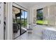 Cozy sun room with a view of the golf course, featuring tile floors, and a sliding glass door to a balcony at 5736 La Puerta Del Sol S Blvd # 254, St Petersburg, FL 33715