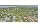 Wide aerial shot of neighborhood with mature trees and landscaping, with lake visible in the distance at 614 Fayette S Dr, Safety Harbor, FL 34695