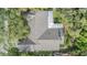 Aerial view of roof with mature tree coverage, and an outdoor patio area visible in the backyard at 614 Fayette S Dr, Safety Harbor, FL 34695
