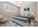 Cozy bedroom with a bed, a soft rug, shuttered windows, and side tables with lamps at 614 Fayette S Dr, Safety Harbor, FL 34695