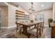 Bright dining room featuring a large wood table with seating for six, wood floors, and a stylish light fixture at 614 Fayette S Dr, Safety Harbor, FL 34695