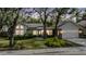 Charming single-story home boasts a well-manicured lawn and mature trees with lush landscaping around the property at 614 Fayette S Dr, Safety Harbor, FL 34695