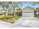 Charming single-story home has a well-manicured lawn and mature trees, creating a welcoming curb appeal at 614 Fayette S Dr, Safety Harbor, FL 34695