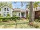 Well-maintained single-story home with lush landscaping and mature trees, providing a beautiful curb appeal at 614 Fayette S Dr, Safety Harbor, FL 34695
