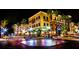 Night shot of a vibrant commercial building with well-lit storefronts and palm trees on a busy city corner at 614 Fayette S Dr, Safety Harbor, FL 34695