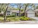 Charming single-story home boasts a well-manicured lawn and mature trees with lush landscaping around the property at 614 Fayette S Dr, Safety Harbor, FL 34695