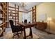 Bright home office featuring wood floors, custom bookshelves, a desk, and a comfortable desk chair at 614 Fayette S Dr, Safety Harbor, FL 34695