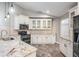 Spacious kitchen with granite countertops, white cabinets, and stainless steel appliances at 614 Fayette S Dr, Safety Harbor, FL 34695