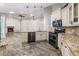 Open kitchen featuring granite countertops, stainless steel appliances, pendant lighting and breakfast bar at 614 Fayette S Dr, Safety Harbor, FL 34695
