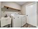 Functional laundry room with washer, dryer, and utility sink at 614 Fayette S Dr, Safety Harbor, FL 34695