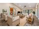 Spacious living room featuring neutral furniture, wood floors, a ceiling fan, and a barn door at 614 Fayette S Dr, Safety Harbor, FL 34695