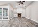 Spacious living room featuring wood tile floors, fireplace, and built-in shelving at 614 Fayette S Dr, Safety Harbor, FL 34695