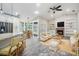 Open-concept living space featuring a kitchen, dining area, living room with fireplace, and a beamed ceiling at 614 Fayette S Dr, Safety Harbor, FL 34695