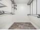 Walk-in closet with wire shelving and wood-look tile flooring that offers functional storage space at 614 Fayette S Dr, Safety Harbor, FL 34695