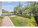 Well-maintained backyard with a brick patio, lush lawn, privacy fence, and green landscaping at 6904 S Macdill Ave # 1, Tampa, FL 33611