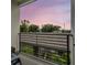 Balcony view of the surrounding area with trees and a beautiful pink and purple sunset at 6904 S Macdill Ave # 1, Tampa, FL 33611