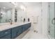 Modern bathroom with double vanity, marble countertop, and glass enclosed shower at 6904 S Macdill Ave # 1, Tampa, FL 33611