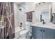 Bathroom featuring a shower-tub combination, gray vanity, and contemporary fixtures at 6904 S Macdill Ave # 1, Tampa, FL 33611