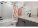 Modern bathroom with a tub-shower combination, stylish gray vanity, and contemporary fixtures at 6904 S Macdill Ave # 1, Tampa, FL 33611
