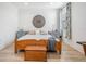 A bright bedroom features a wooden bed frame, light wood floors, and a decorative wall hanging at 6904 S Macdill Ave # 1, Tampa, FL 33611
