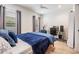 Comfortable bedroom featuring a plush blue comforter, ample natural light, and a workspace at 6904 S Macdill Ave # 1, Tampa, FL 33611