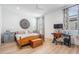 Bright bedroom with a wooden bed frame, blue accents, and a workspace featuring a computer desk at 6904 S Macdill Ave # 1, Tampa, FL 33611
