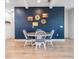 Cozy dining area featuring a round table with white chairs set against a navy accent wall with decorative artwork at 6904 S Macdill Ave # 1, Tampa, FL 33611