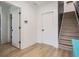 Bright entryway with wood-look flooring, white doors, and stairway to the second level at 6904 S Macdill Ave # 1, Tampa, FL 33611